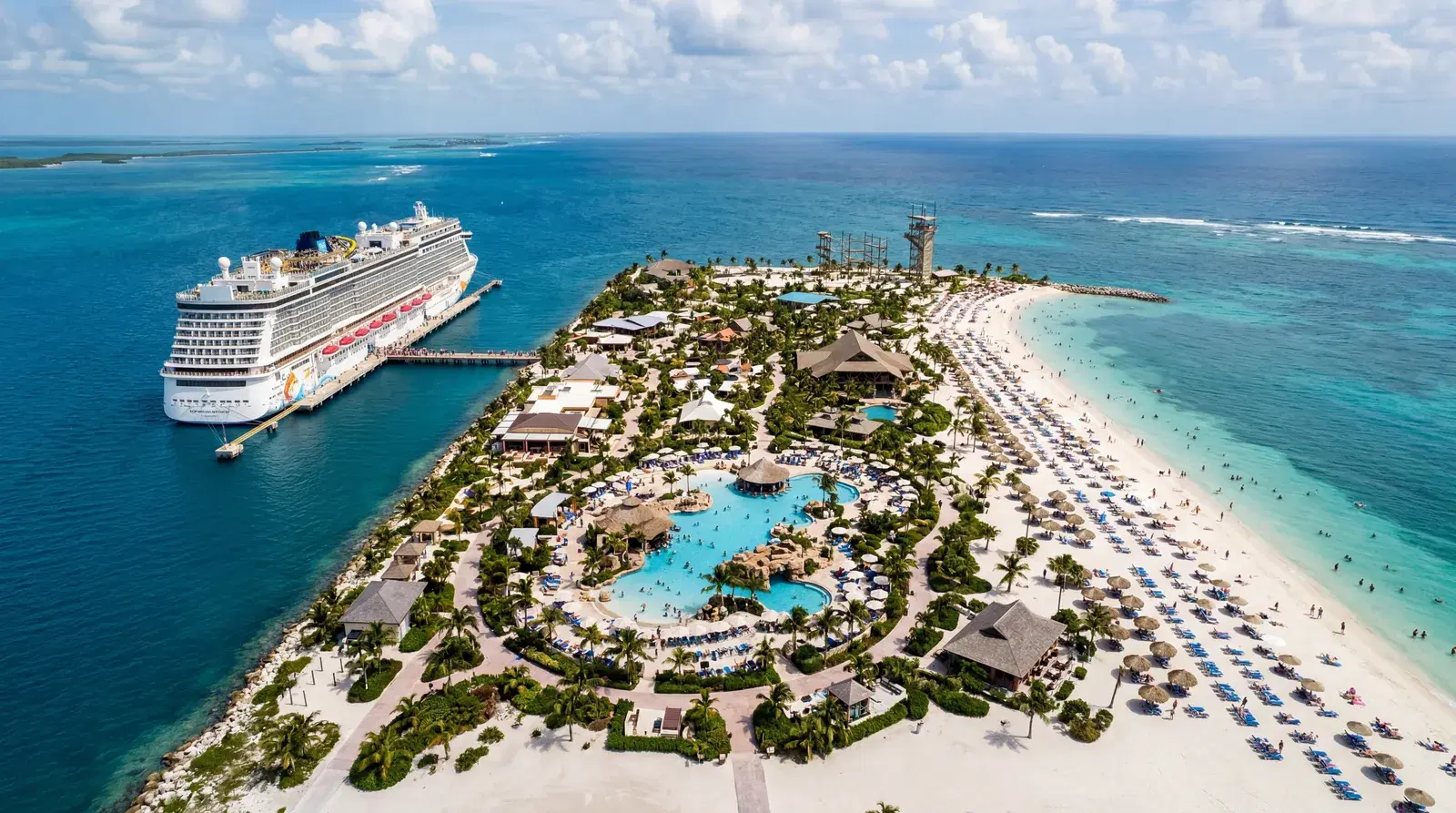 Harvest Caye Belize Norwegian Cruise Line private island resort, manufactured beach, resort pools, luxury facilities on small cay, Caribbean sea surrounding, completely isolated private resort atmosphere, documentary travel photography, photorealistic, no text, no watermark, 16:9