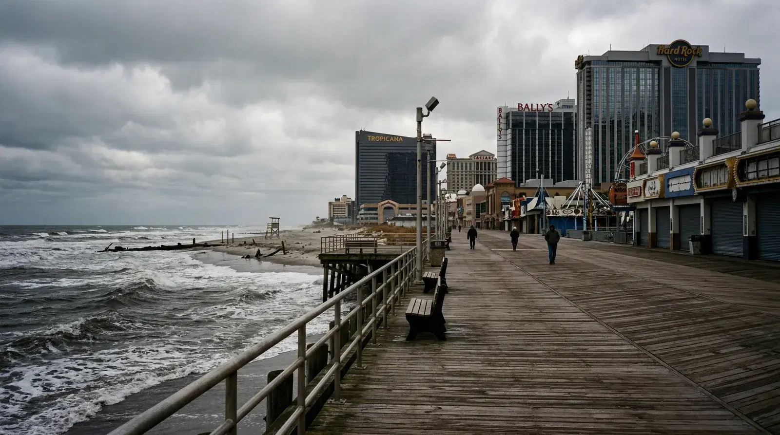 Atlantic City New Jersey boardwalk in off-season, casinos looming in the background, nearly empty boardwalk, grey choppy Atlantic, overcast sky. documentary travel photography, realistic, no text, no watermark, 16:9