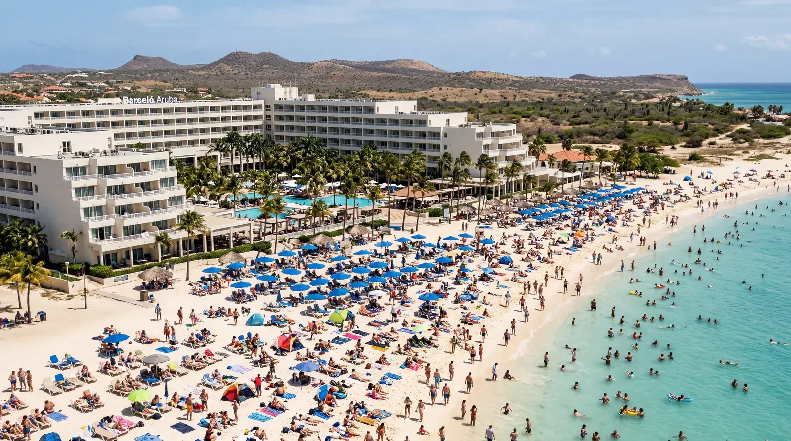 Realistic editorial photo of a Caribbean resort beach with narrow sand, towel-covered chairs, and hotel buildings close 
