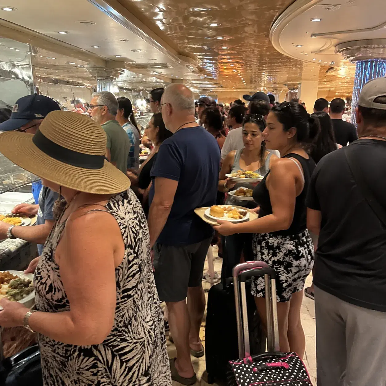 Realistic editorial photo of crowded cruise ship elevator lobby with luggage, passengers waiting, and staircase nearby,