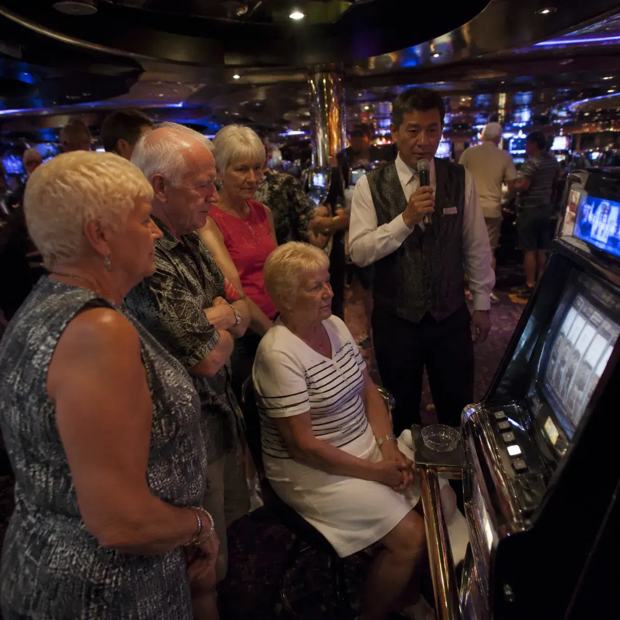 Realistic editorial photo of a quiet cruise ship casino with slot machines, players cards, and dim colorful lighting, no