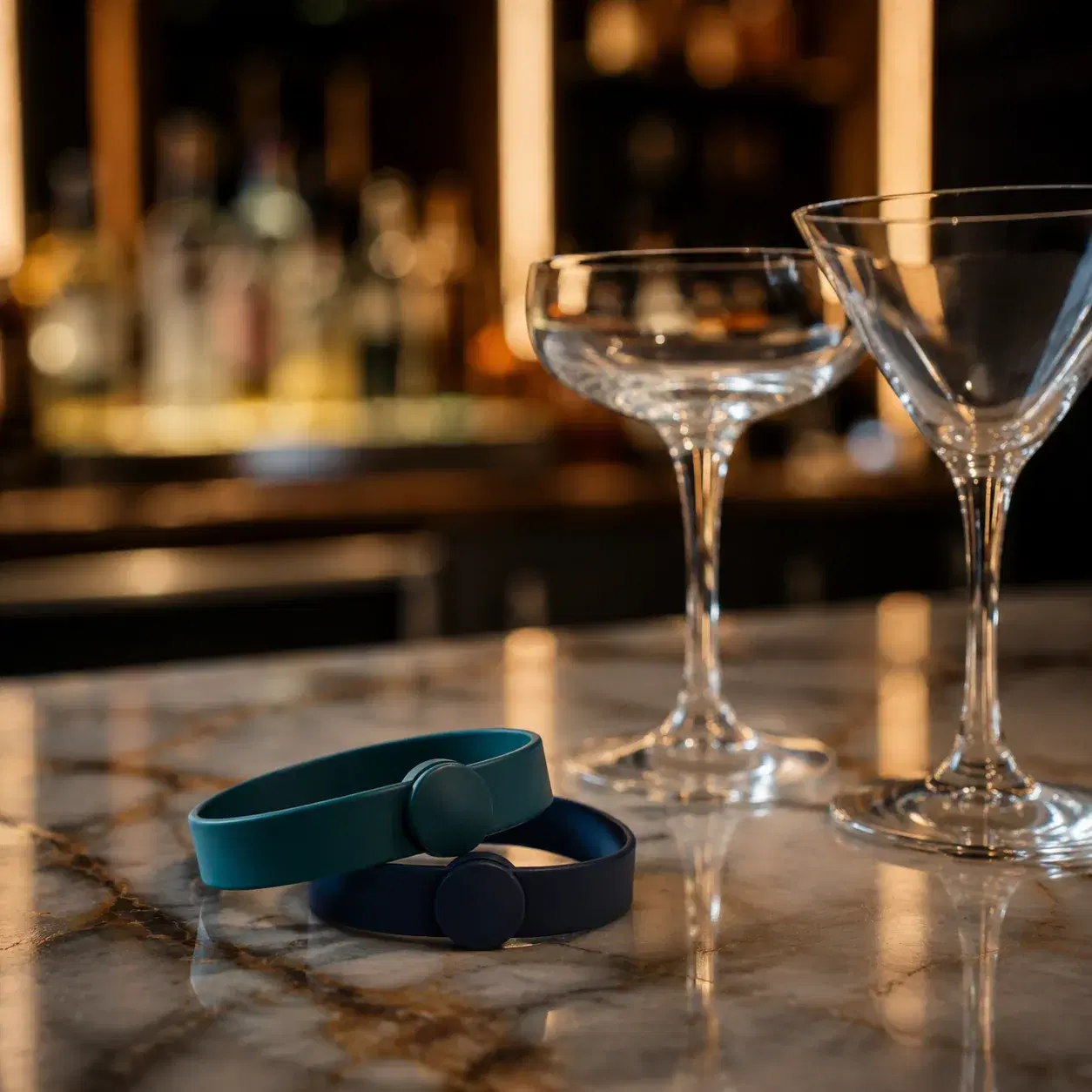 Realistic editorial photo of novelty cruise souvenir cups on a bar table with ocean deck blurred behind them, bright vac