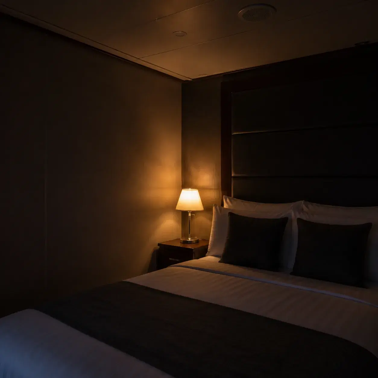 Realistic editorial photo of folded cruise clothes, packing cubes, and a laundry bag on a cabin bed, soft daylight from