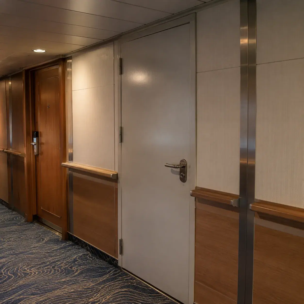 Realistic editorial photo of cruise cabin hallway with room doors closed, housekeeping cart, and passenger carry-on wait