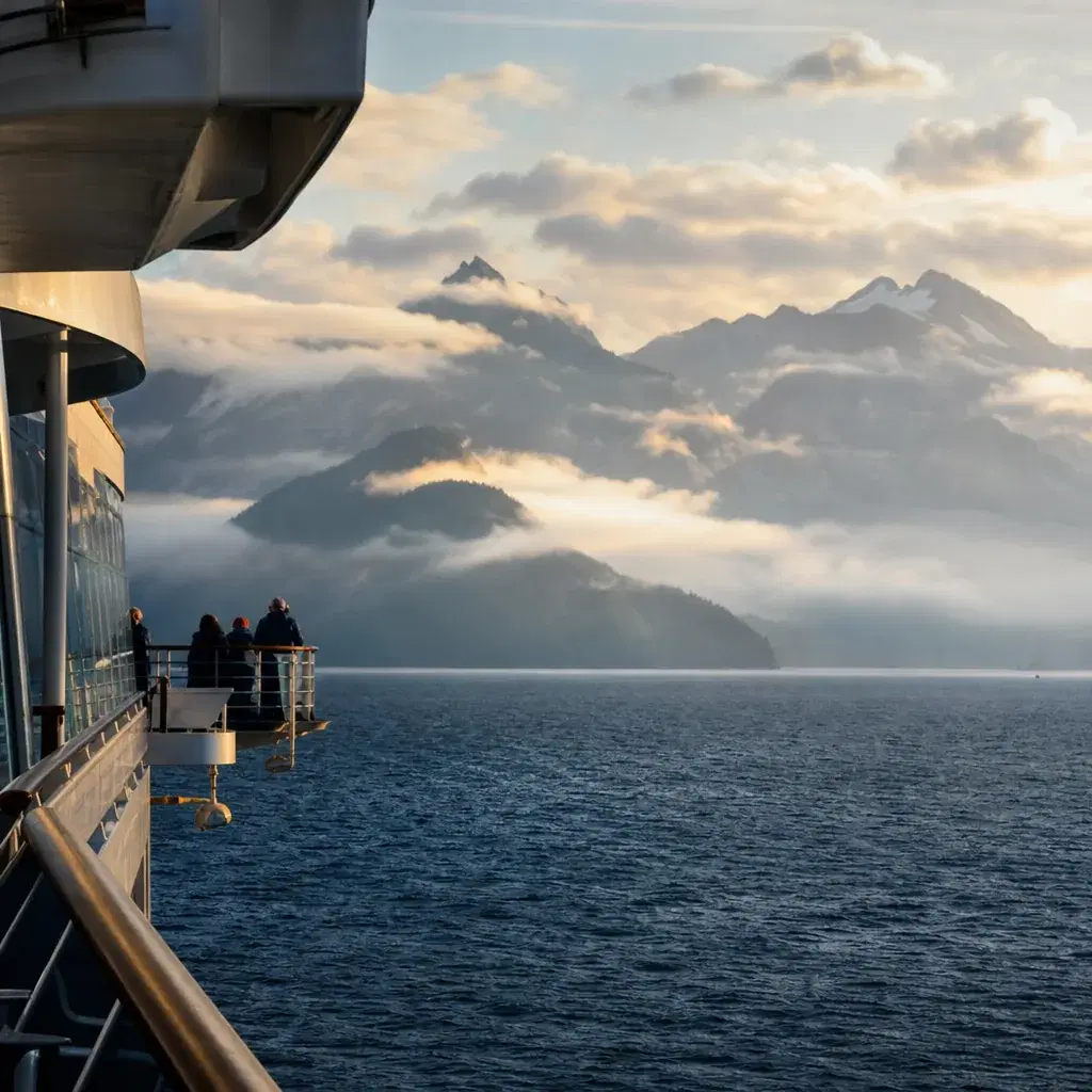 Realistic editorial photo of Alaska cruise scene showing wrong side of the ship for your route, misty mountains and ship