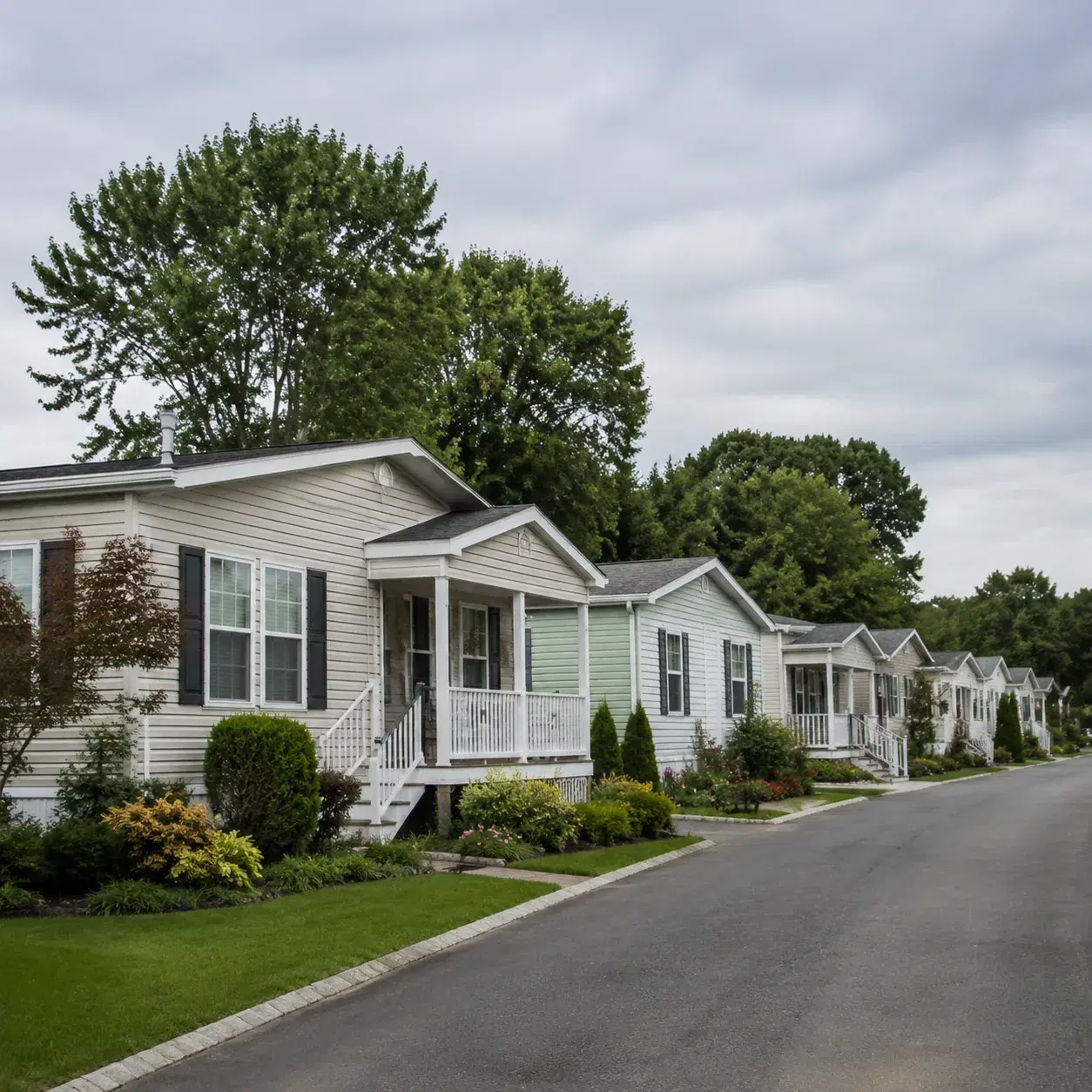 Realistic editorial photo of a 55 plus manufactured home community on eastern Long Island with small homes, tidy porches