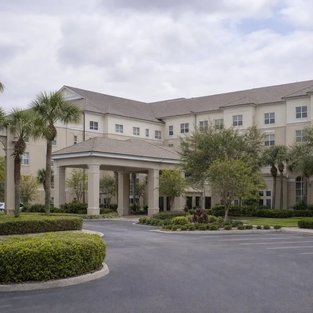 Fresh square editorial photo of a continuing care retirement community building in Florida with institutional architecture, q