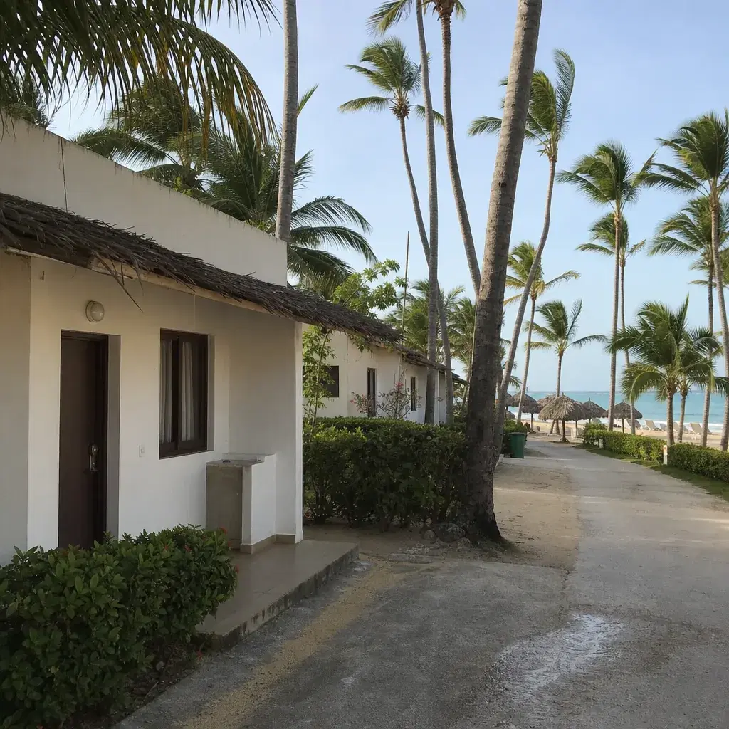 Realistic editorial photo of Punta Cana all-inclusive resort scene showing lowest price room near service roads, palms a