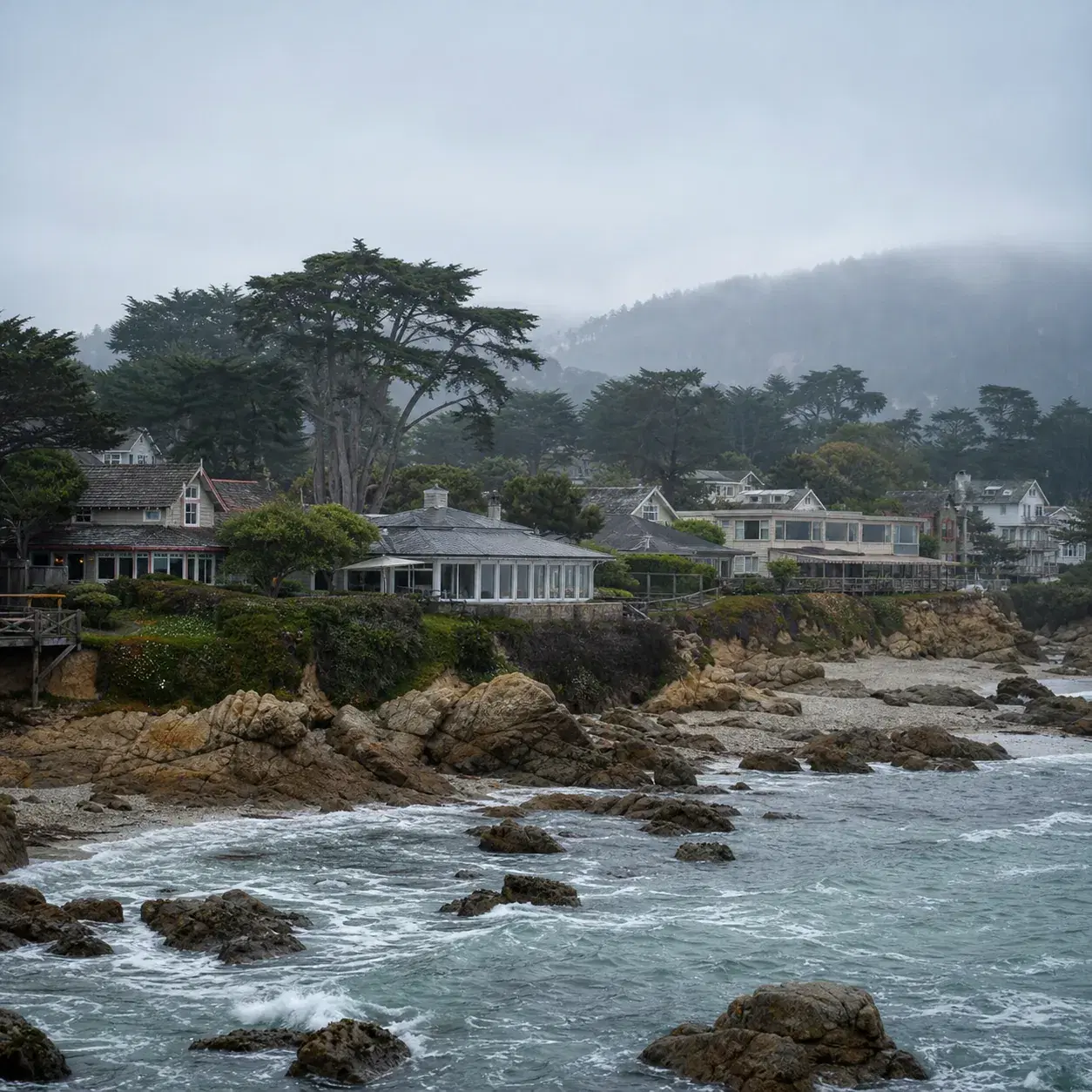 Realistic editorial photo of Cambria California coastal village with cypress trees, small inns, rocky shoreline, and sof
