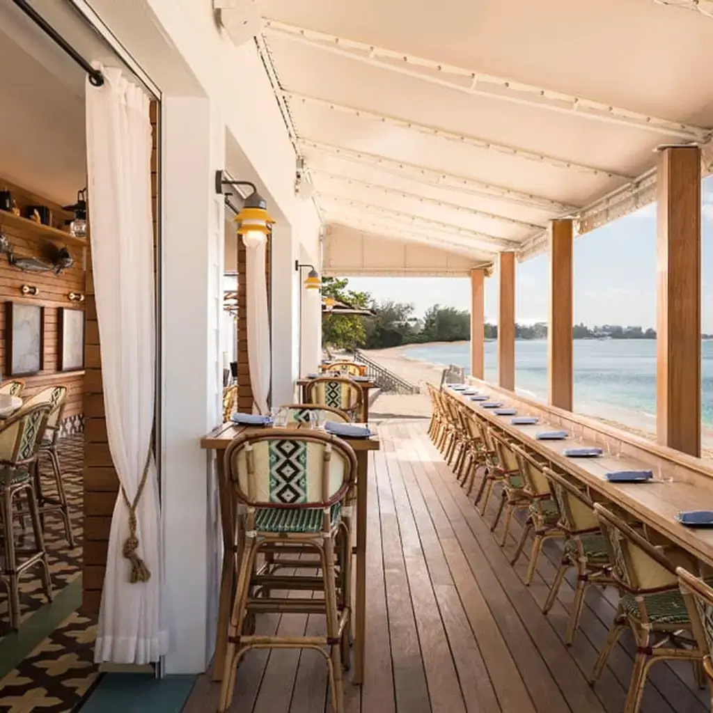 Beachfront dining terrace at Kimpton Seafire Resort and Spa in Grand Cayman