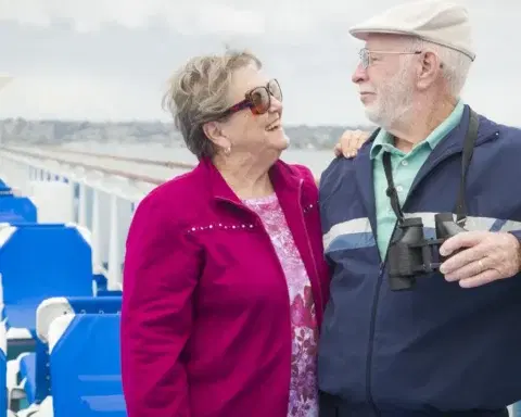 Couple in their eighties enjoying the view from a cruise ship deck