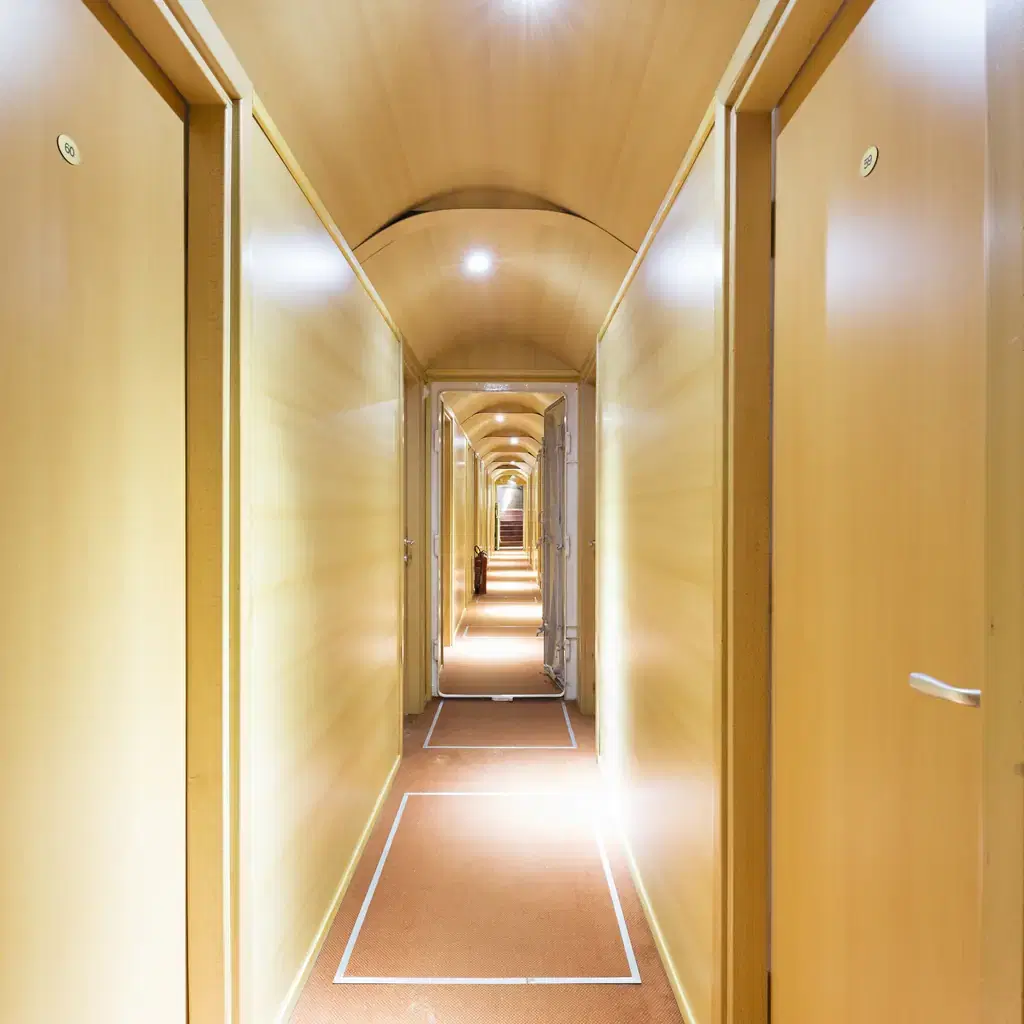 A long passenger corridor inside a cruise ship