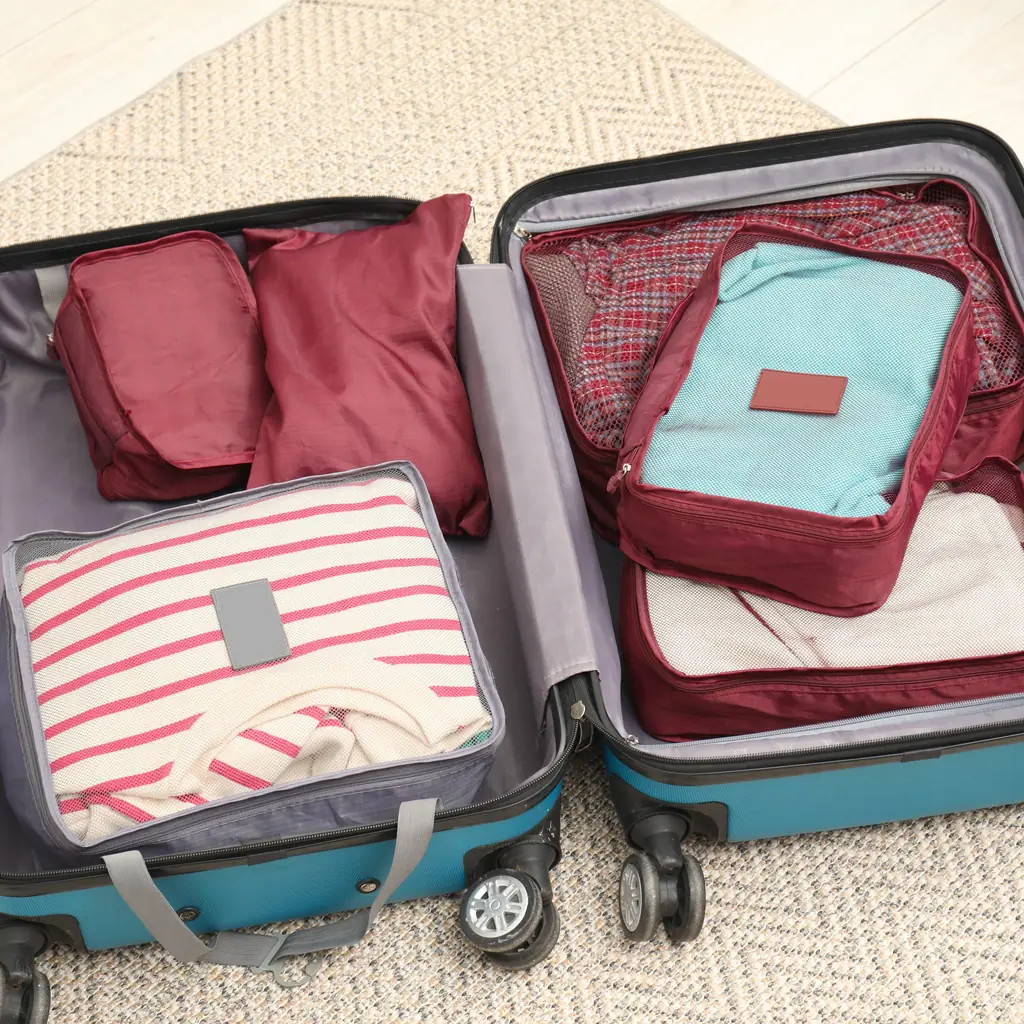 Packing cubes arranged inside an open suitcase