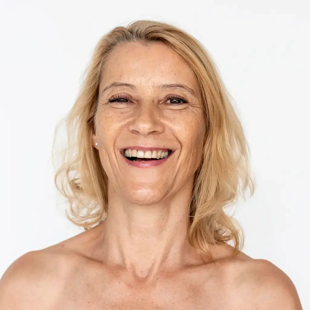 A smiling woman with shoulder-length blonde hair and soft long layers