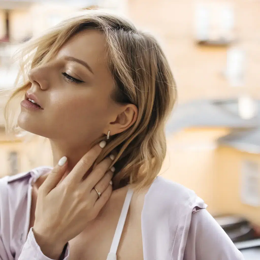 A woman with a short bob tucked behind one ear