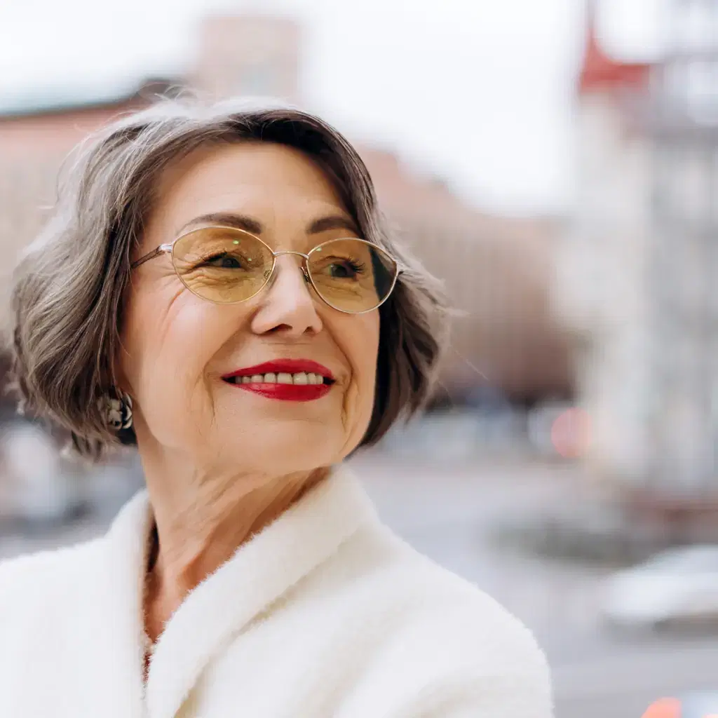 A woman wearing glasses with a short grey bob