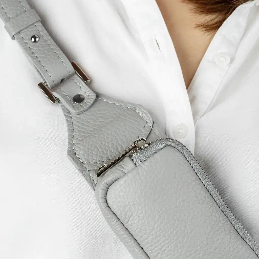A small crossbody bag worn over a shirt