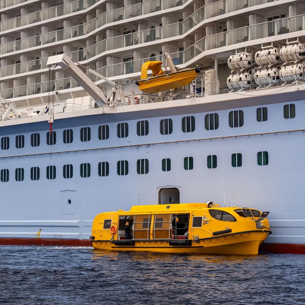 A yellow tender boat beside a cruise ship off Kona, Hawaii