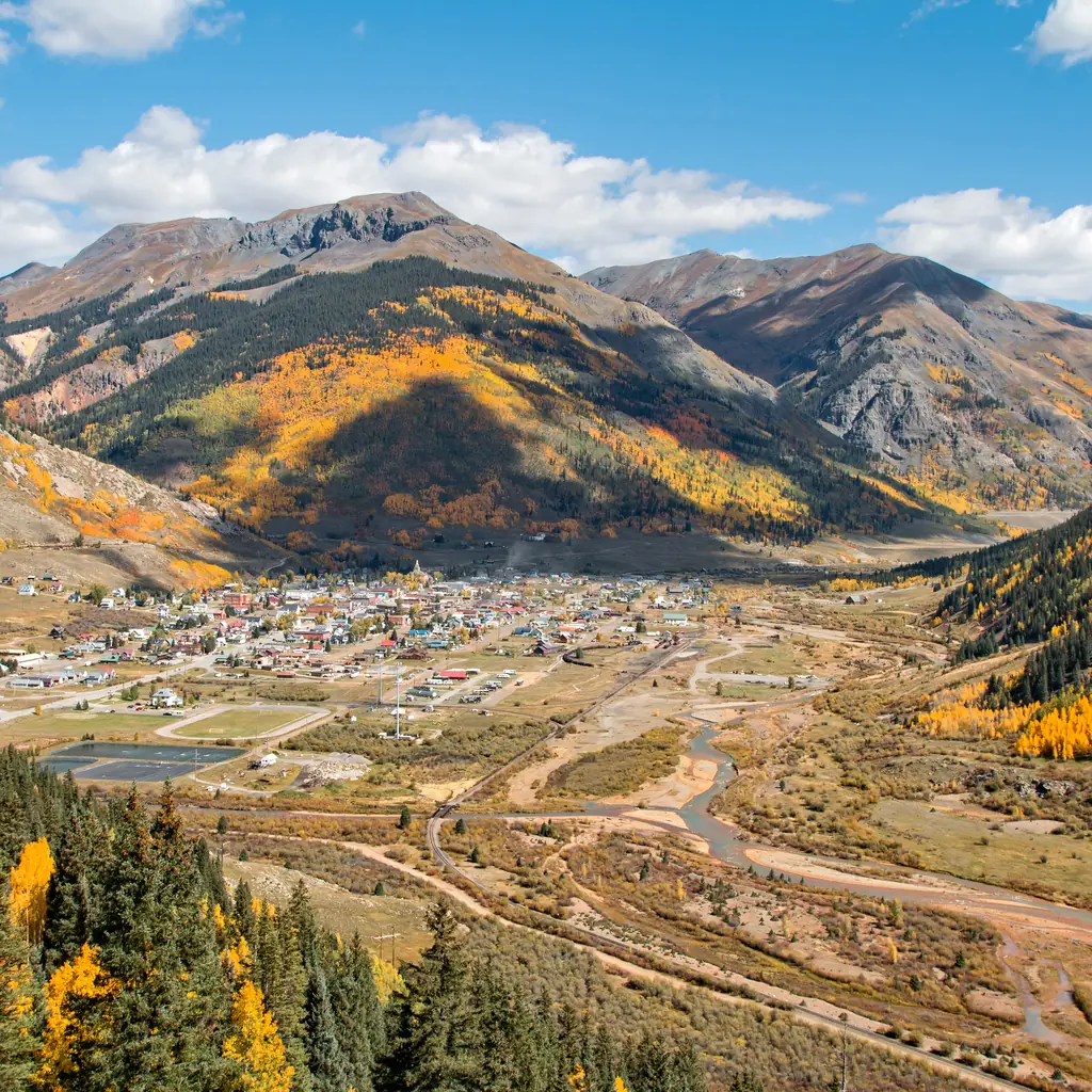 Silverton, Colorado, surrounded by mountains and autumn foliage.