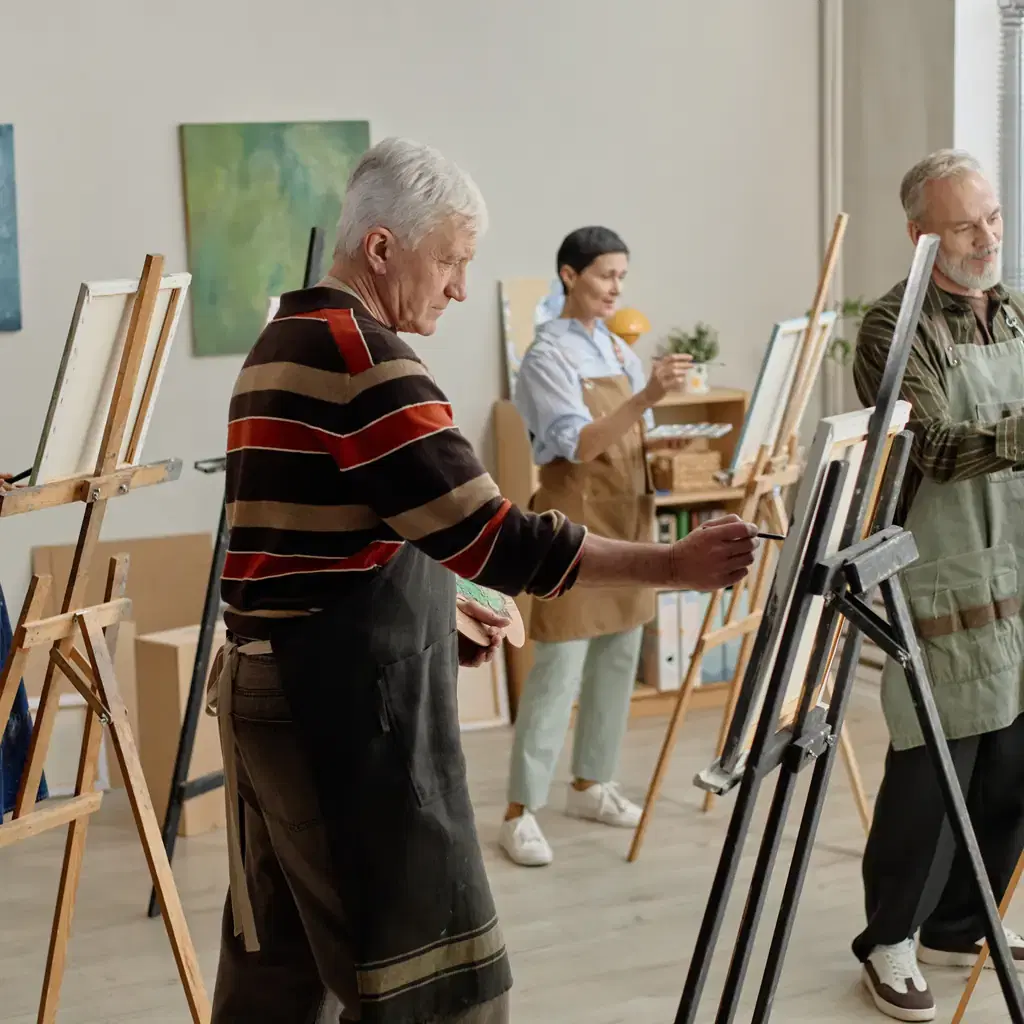 Illustrative stock photograph of older adults at an art workshop; not the Ava Art Guild.