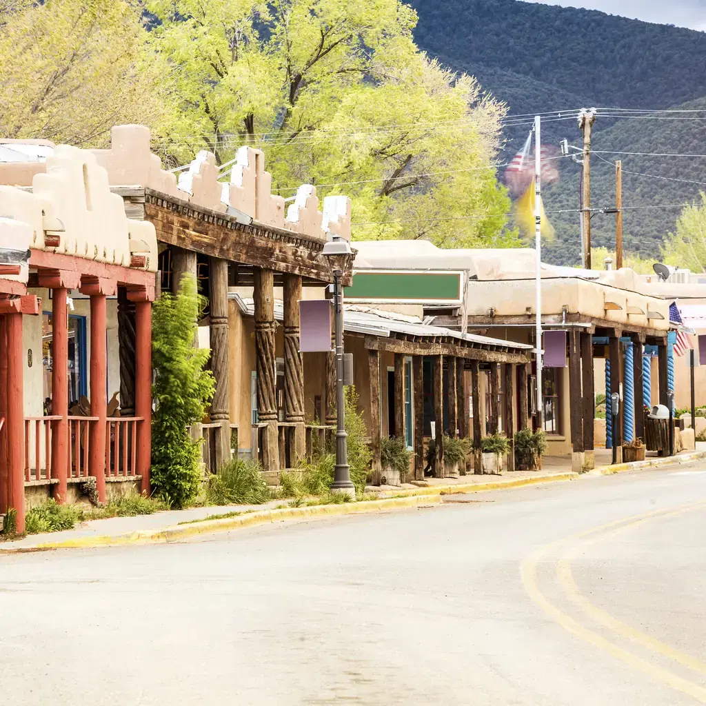 Adobe-style storefronts along a street in Taos, New Mexico.