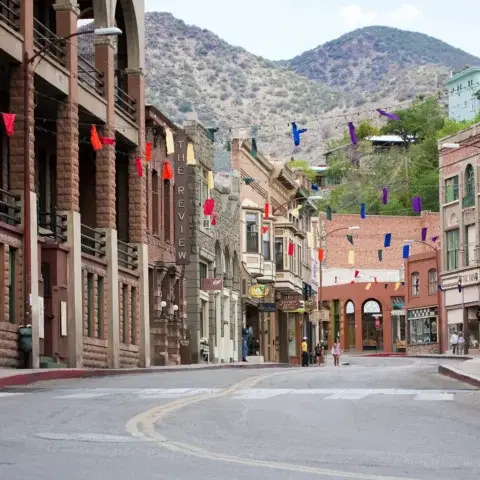 Historic downtown buildings in Bisbee, Arizona, below the surrounding hills.