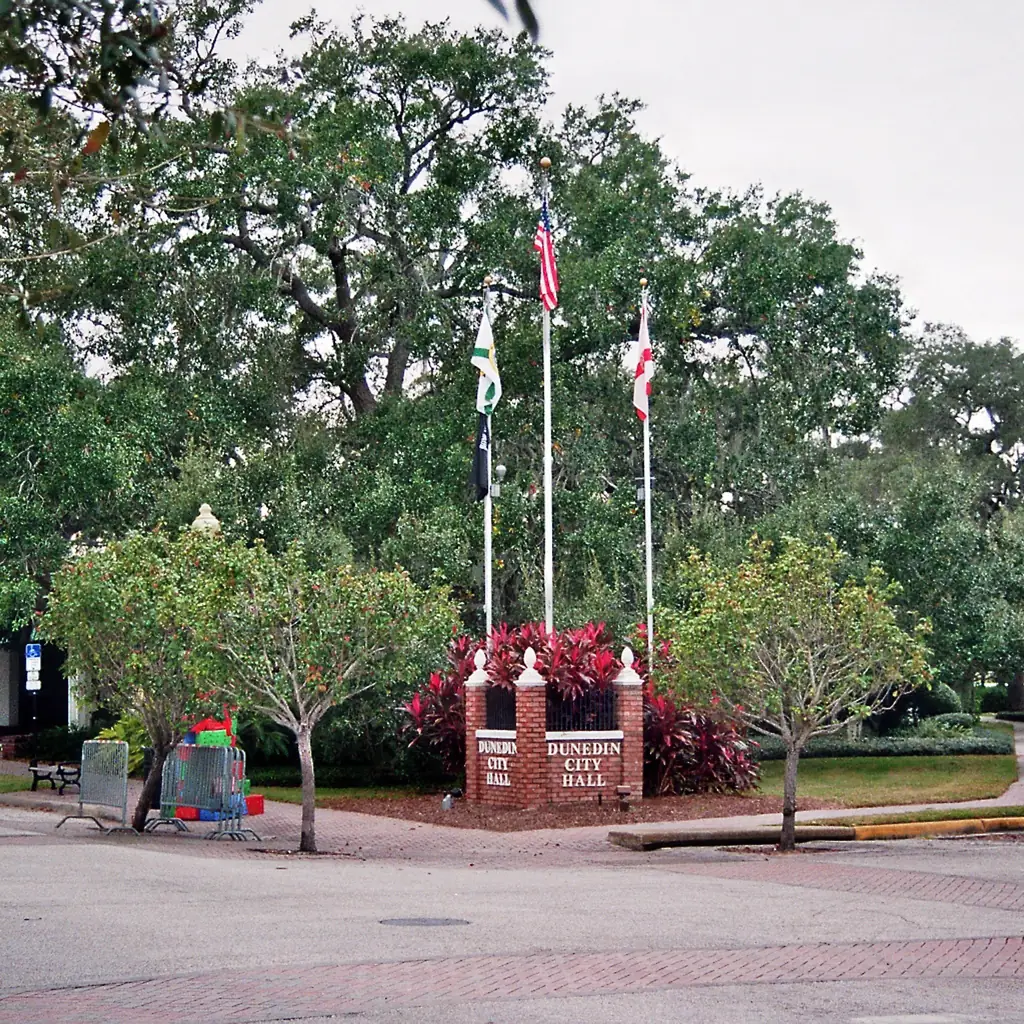 A war memorial and tree-lined grounds in Dunedin, Florida.