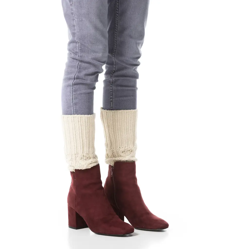 Thick doubled socks bunched at the ankle while pulling on a winter boot