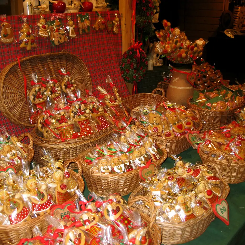 A Christmas market stall piled with baskets of gifts and festive treats