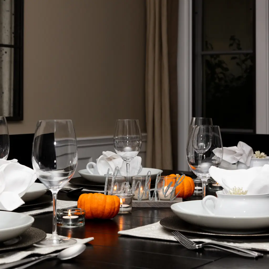 A fleece quarter-zip pullover draped over a chair at a candlelit holiday dinner table