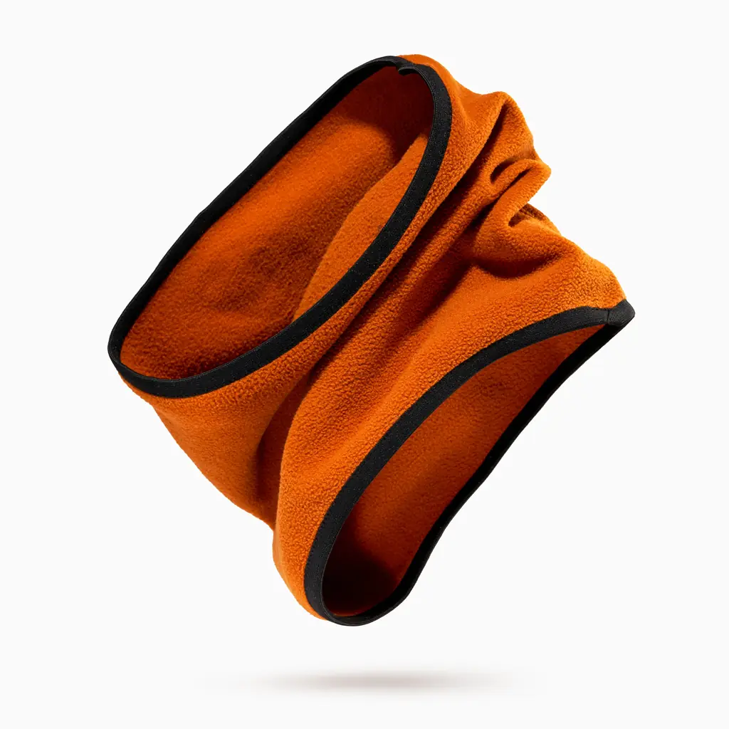 A person on a cold city street wearing a plain dark neck gaiter pulled up over the nose