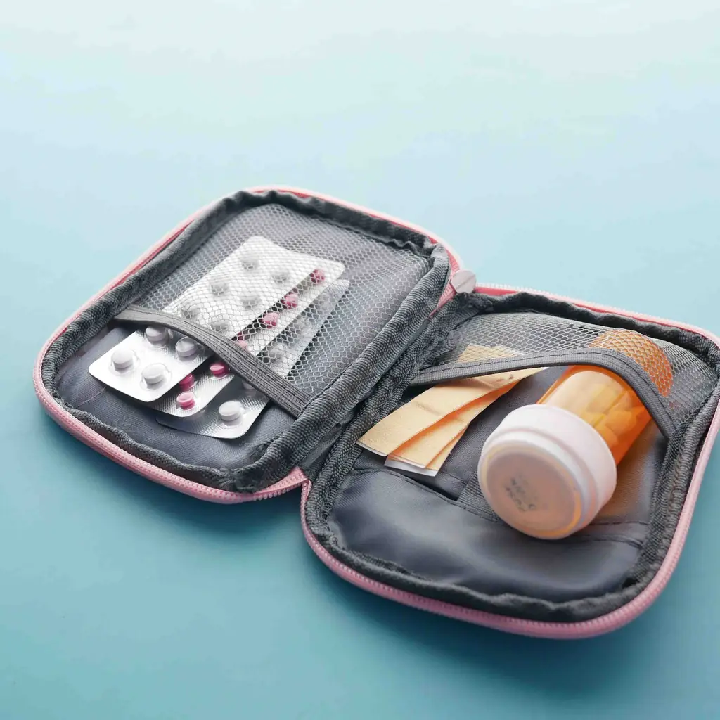 A small insulated medication pouch tucked into the inside pocket of a winter coat