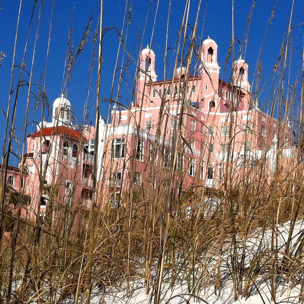 The pink Don CeSar hotel rising above the sand on St. Pete Beach