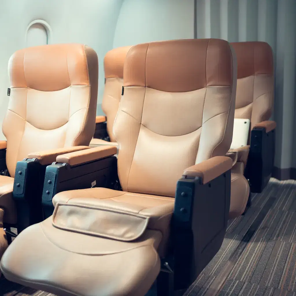 Wide premium economy seats with leg rests and extra legroom in an airplane cabin