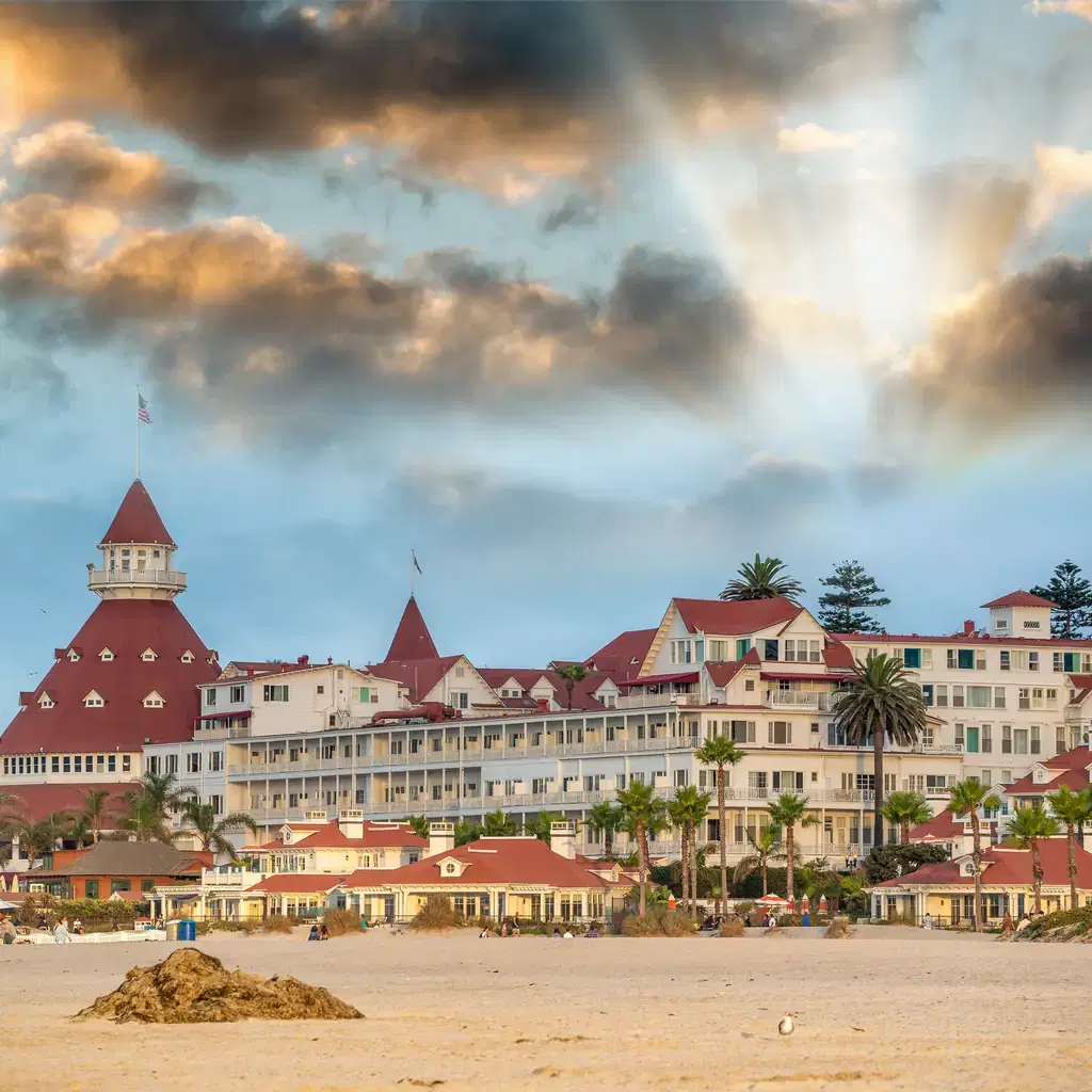 Hotel del Coronado's red Victorian roofs seen from the beach