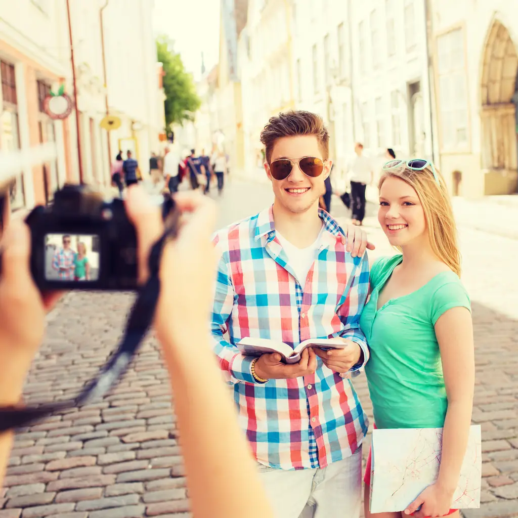 A small group of friends exploring a European city street with a map, illustrating a smaller headcount operator.