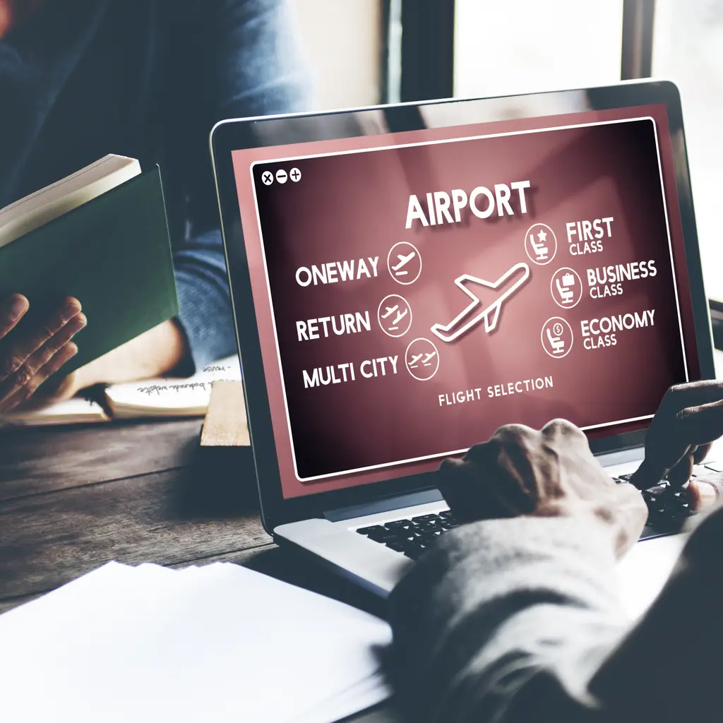 A laptop screen showing first class, business class, and economy class flight selection options, illustrating why checking the seat map for the exact flight beats guessing from the fare name.