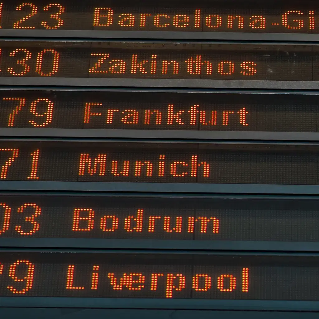 A departure board listing many different city destinations, illustrating how pacing is set by how many cities are packed into a week.