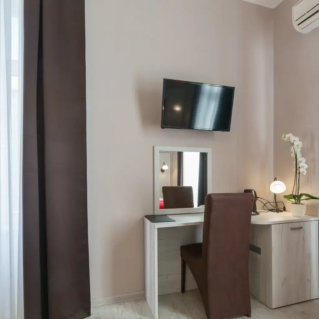 The corner of a hotel room with a vanity desk and mirror, illustrating a corner room a guest can simply request.