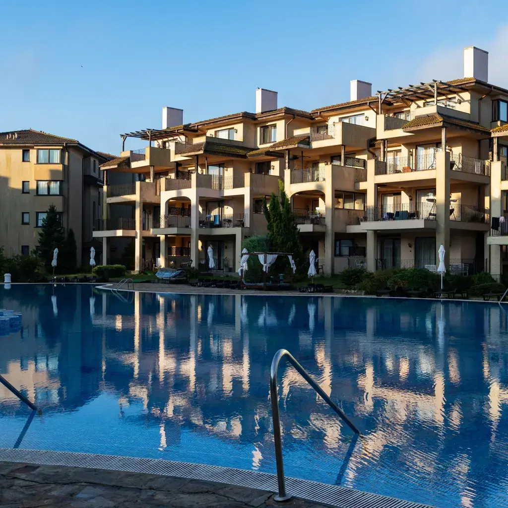 Resort rooms with direct pool access and reflections at dusk, illustrating a swim-up room category.
