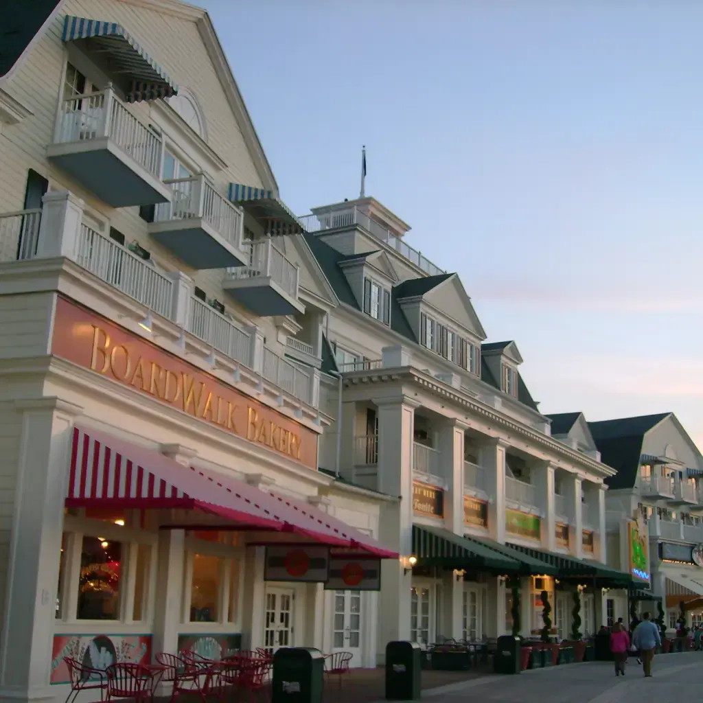 Disney's BoardWalk Inn storefronts at dusk, an EPCOT-area resort reachable by boat or on foot.