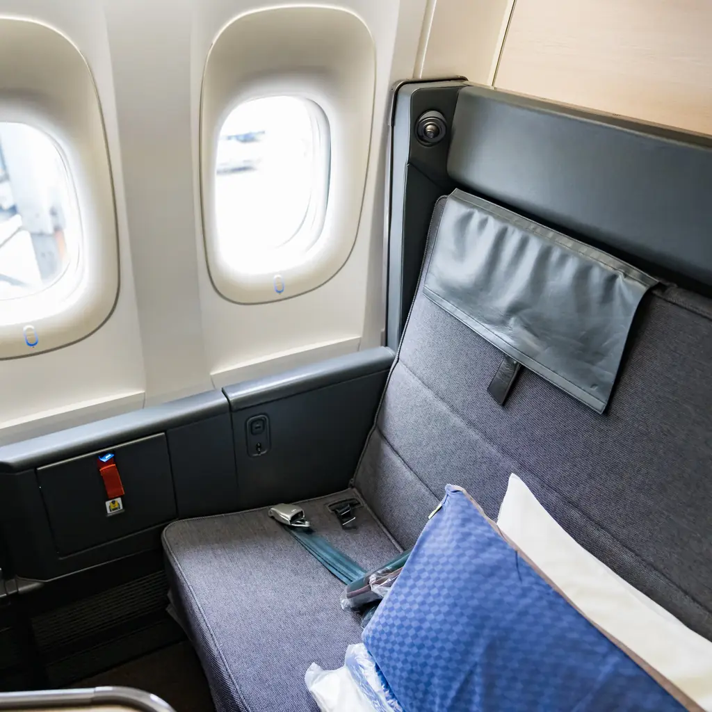 An open business class seat without a privacy door, illustrating that not every airline has adopted the enclosed suite design.